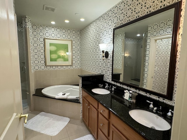 bathroom with oversized vanity, independent shower and bath, double sink, and tile flooring