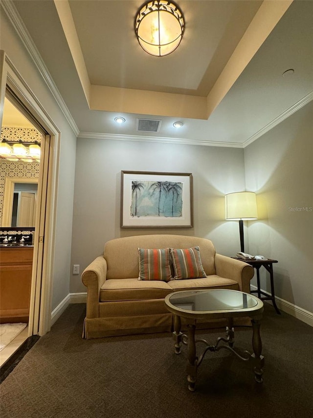 carpeted living room featuring a raised ceiling and ornamental molding