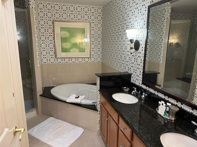 bathroom featuring tile floors, independent shower and bath, and double vanity