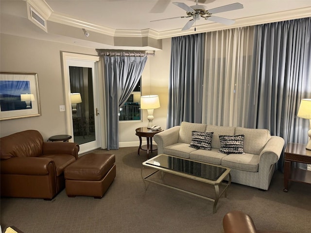 carpeted living room featuring crown molding, ceiling fan, and a tray ceiling