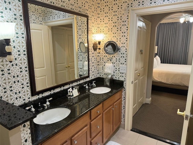 bathroom with tile floors, dual sinks, ceiling fan, and large vanity