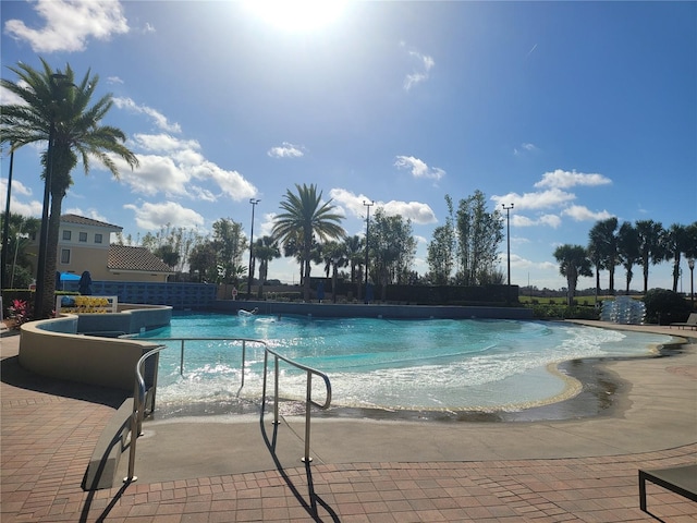 view of swimming pool with a patio area and pool water feature