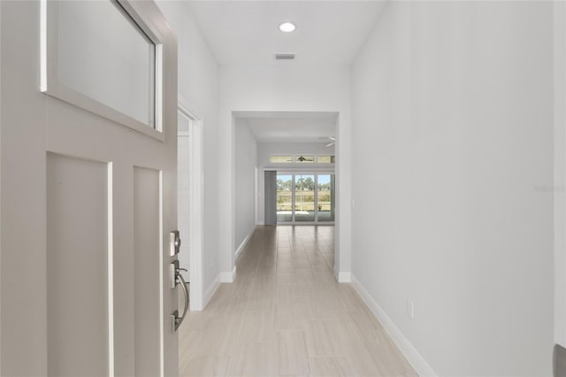 corridor featuring light tile patterned floors