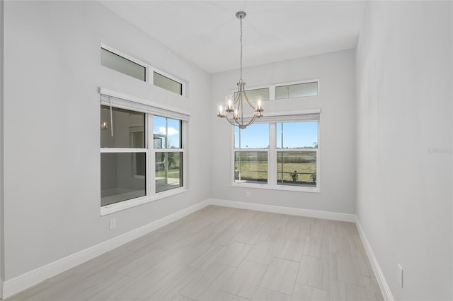 unfurnished dining area featuring a notable chandelier