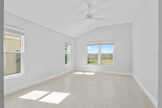 empty room with ceiling fan and vaulted ceiling