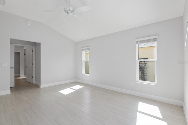 unfurnished room featuring ceiling fan, vaulted ceiling, and a wealth of natural light