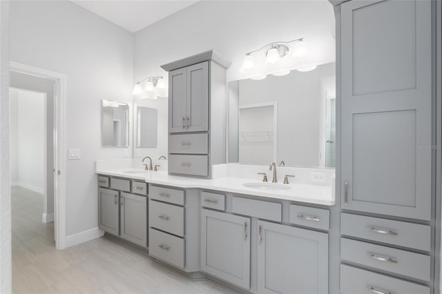 bathroom with tile patterned floors and dual vanity