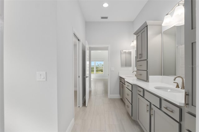 bathroom with double vanity and tile patterned floors