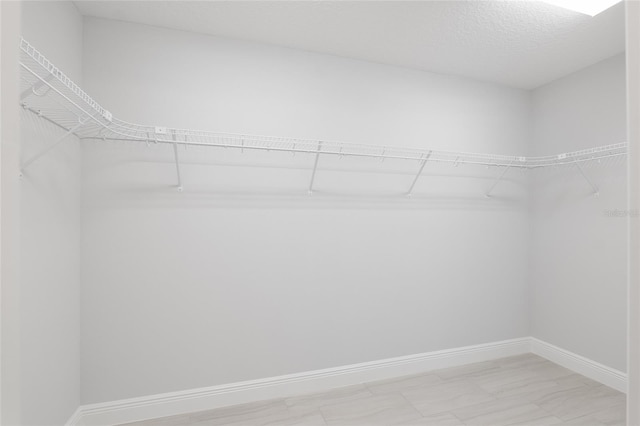 spacious closet featuring tile patterned floors