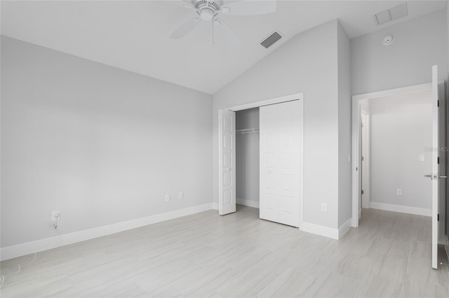 unfurnished bedroom featuring lofted ceiling, a closet, and ceiling fan