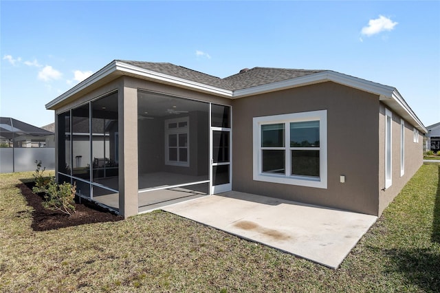 rear view of property with a patio, a sunroom, and a yard