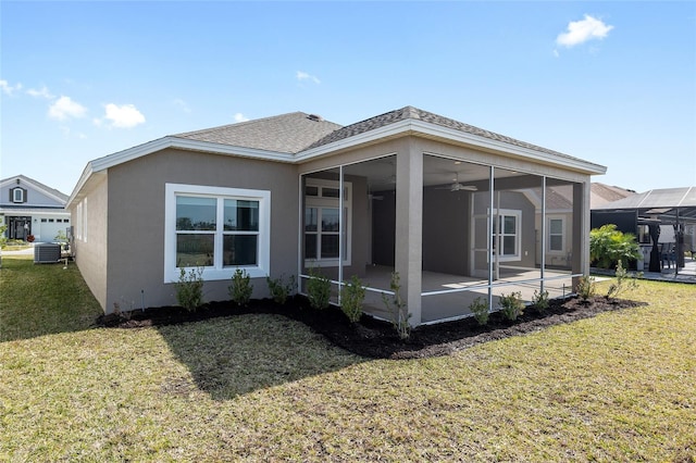 back of house with central AC, a sunroom, a lanai, and a yard