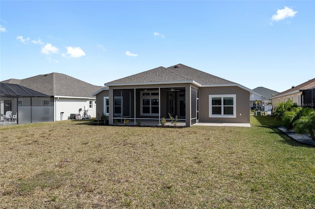 rear view of property with a sunroom and a yard