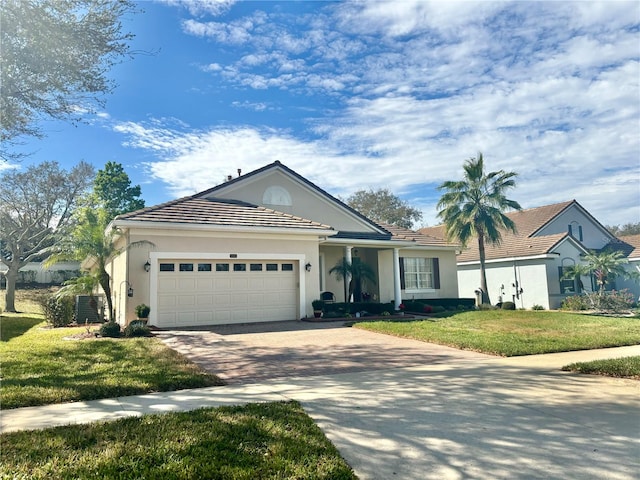 ranch-style house with central air condition unit, a front lawn, and a garage