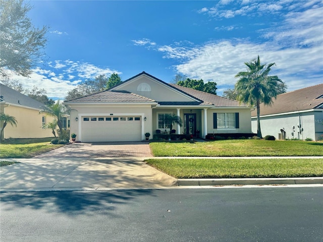 ranch-style home featuring a garage and a front yard