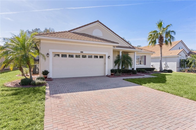 view of front of property with a garage, central AC unit, and a front lawn