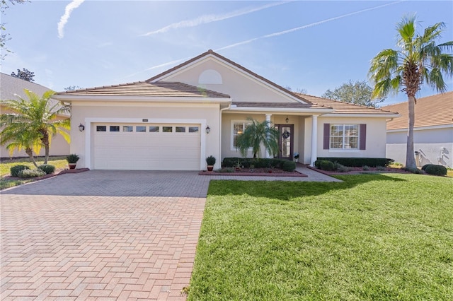 view of front of property with a garage and a front lawn