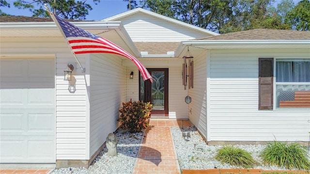 view of exterior entry featuring a garage