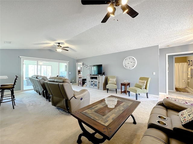 carpeted living room with vaulted ceiling, a textured ceiling, and ceiling fan