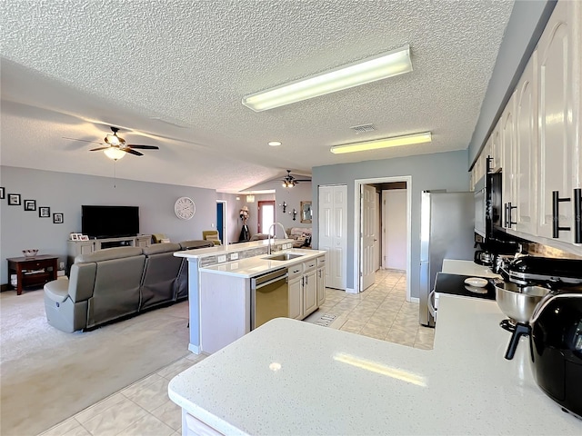 kitchen with a kitchen island with sink, light tile flooring, ceiling fan, and sink