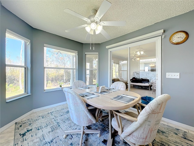 dining area with light tile floors, a textured ceiling, and ceiling fan