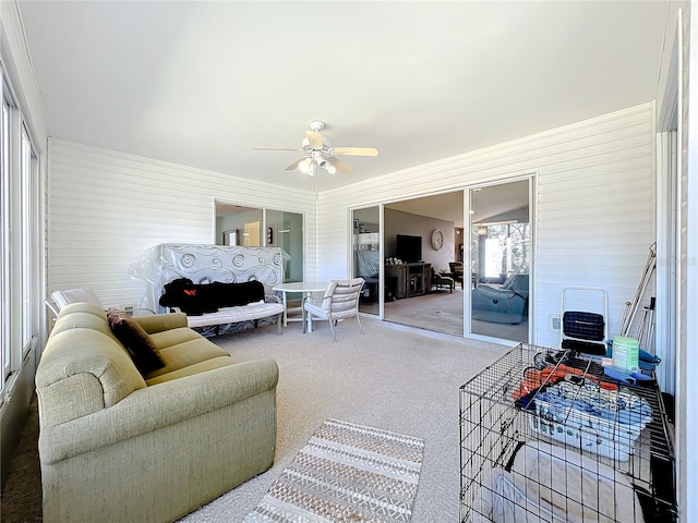 living room featuring carpet and ceiling fan