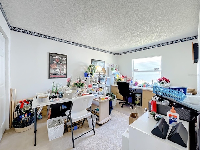 office area with light carpet and a textured ceiling