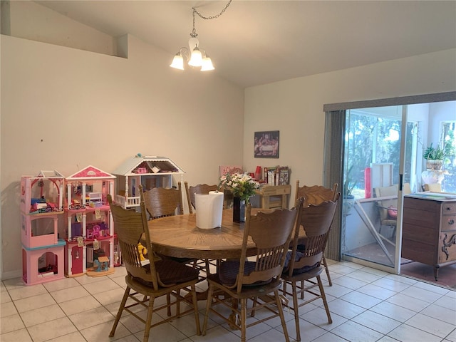 tiled dining area featuring a notable chandelier and lofted ceiling