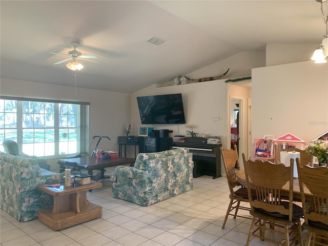 living room featuring light tile flooring, ceiling fan, and lofted ceiling