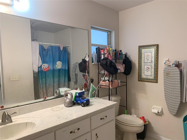 bathroom with toilet and vanity