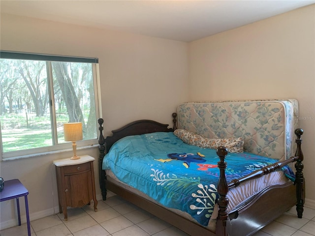 bedroom featuring light tile floors and multiple windows