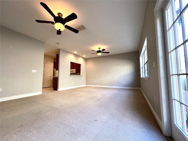 carpeted empty room featuring ceiling fan