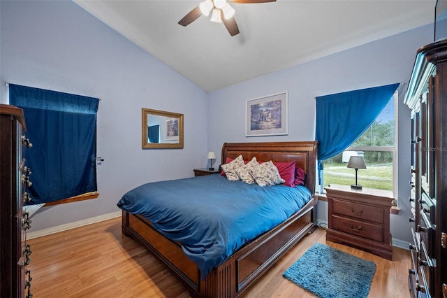 bedroom with lofted ceiling, ceiling fan, and light hardwood / wood-style flooring