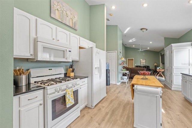 kitchen with white appliances, butcher block counters, white cabinets, and light hardwood / wood-style flooring