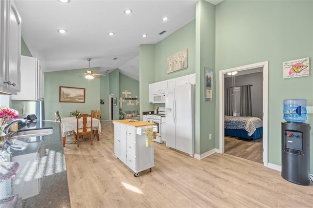 kitchen with ceiling fan, white appliances, sink, light hardwood / wood-style flooring, and white cabinets