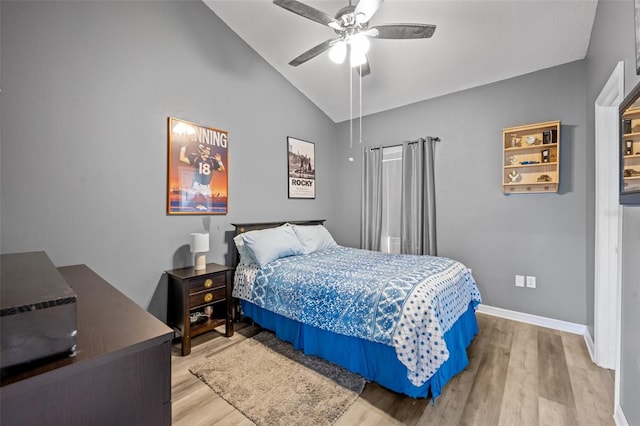 bedroom featuring high vaulted ceiling, ceiling fan, and light wood-type flooring