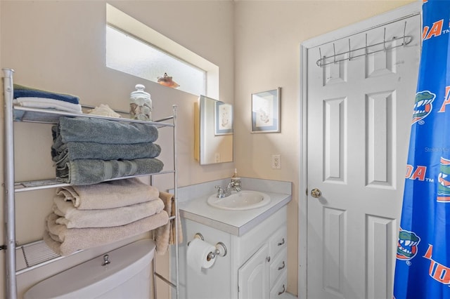 bathroom featuring toilet and vanity