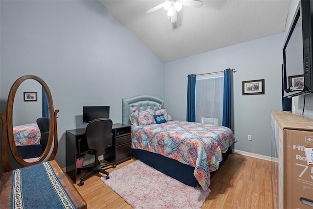 bedroom featuring ceiling fan, vaulted ceiling, and light hardwood / wood-style flooring