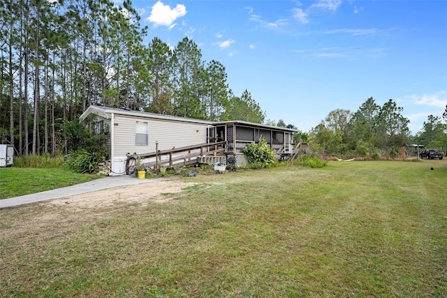 rear view of house featuring a yard