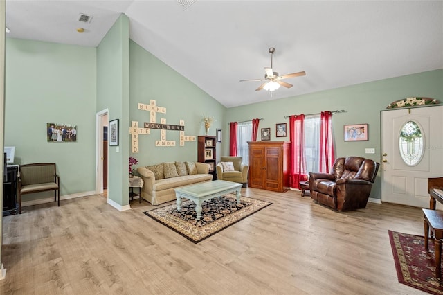 living room featuring high vaulted ceiling, ceiling fan, and light wood-type flooring