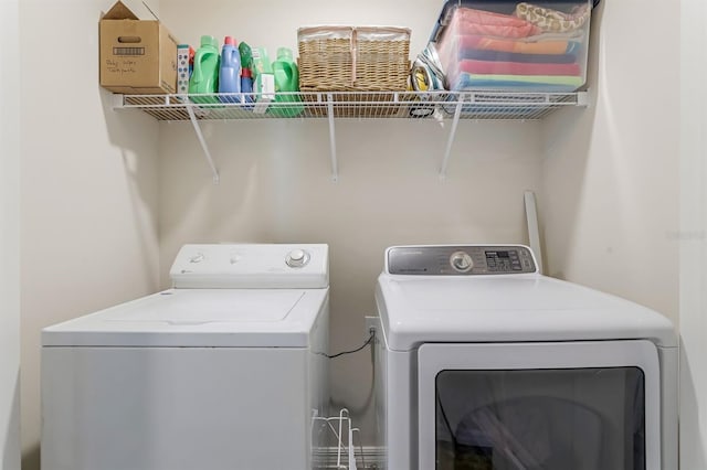 clothes washing area featuring washer and clothes dryer