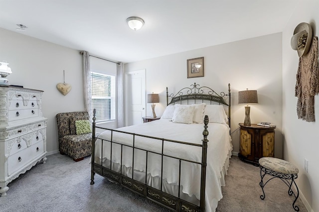 bedroom with carpet floors and baseboards