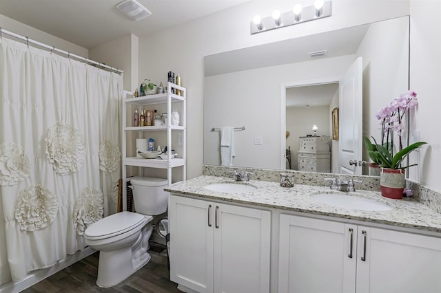 bathroom featuring walk in shower, vanity, toilet, and hardwood / wood-style floors