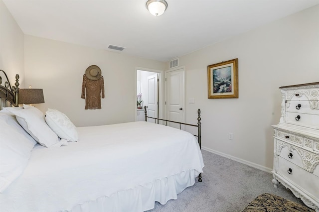 bedroom with visible vents, light carpet, and baseboards