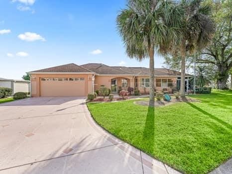 view of front of property with a front yard and a garage