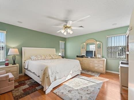 bedroom featuring ceiling fan and light hardwood / wood-style floors