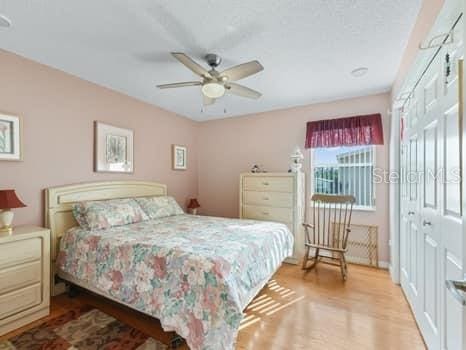 bedroom featuring a closet, ceiling fan, and light hardwood / wood-style flooring