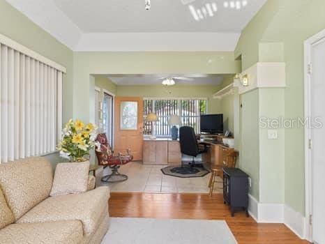 home office with light tile flooring and ceiling fan