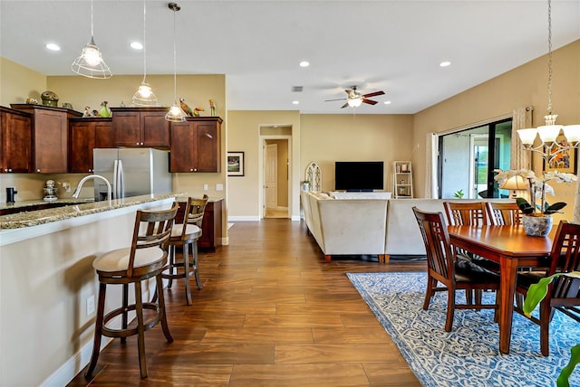 dining space featuring ceiling fan and dark hardwood / wood-style flooring