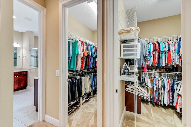 spacious closet with tile flooring